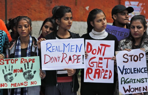 Women activists hold banners and participate in a protest demanding justice in the case of a veterinarian who was gang-raped and killed last week, in New Delhi, India, Tuesday, Dec. 3, 2019. The burne ...