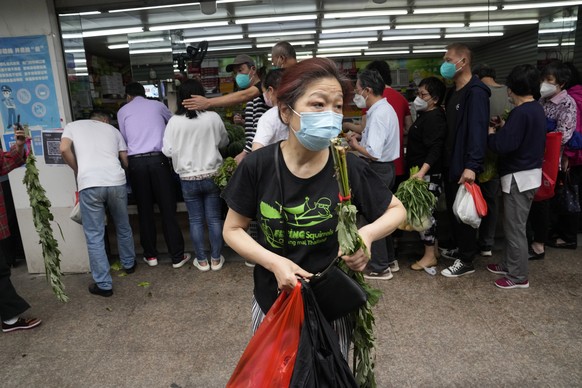 Residents line up to buy vegetables at a market, Wednesday, June 1, 2022, in Shanghai. Shanghai authorities say they will take major steps Wednesday toward reopening China&#039;s largest city after a  ...