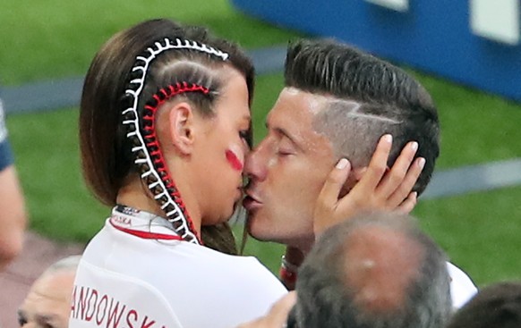 epa06821881 Robert Lewandowski of Poland (R) reacts with his wife Anna after losing the FIFA World Cup 2018 group H preliminary round soccer match between Poland and Senegal in Moscow, Russia, 19 June ...