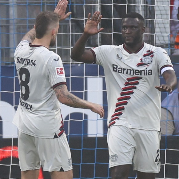 epa11335797 Victor Boniface of Leverkusen (R) celebrates after scoring the 0-2 goal during the German Bundesliga soccer match between VfL Bochum and Bayer Leverkusen in Bochum, Germany, 12 May 2024. E ...