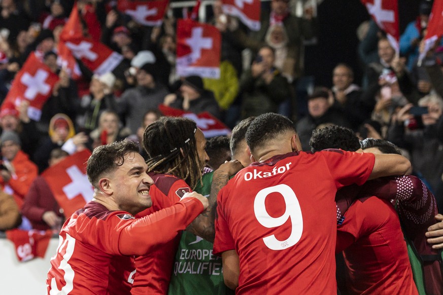 Swiss players with midfielder Xherdan Shaqiri, left, celebrate during the 2022 FIFA World Cup European Qualifying Group C match between Switzerland and Bulgaria at the Swissporarena stadium in Lucerne ...