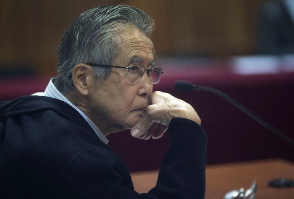 FILE - Peru&#039;s jailed, former President Alberto Fujimori, photographed through a glass window, attends his trial at a police base on the outskirts of Lima, Peru, June 28, 2016. A Peruvian judge on ...