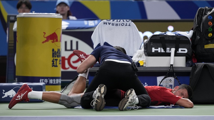 Novak Djokovic of Serbia receives medical timeout during the men&#039;s singles semifinals match against Taylor Fritz of the United States in the Shanghai Masters tennis tournament at Qizhong Forest S ...