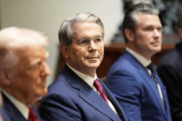 Treasury Secretary Scott Bessent and Defense Secretary Pete Hegseth listen as President Donald Trump speaks before a luncheon with Italy&#039;s Prime Minister Giorgia Meloni in the Cabinet Room of the ...