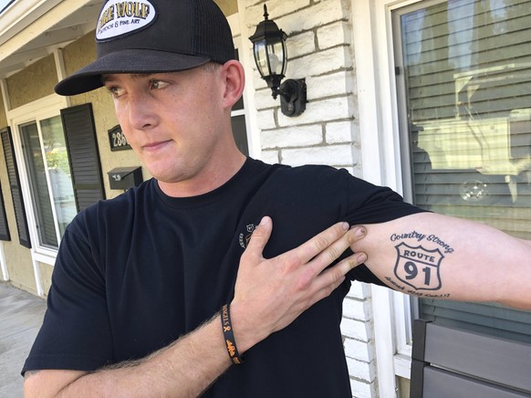 Brendan Kelly speaks with reporters outside his home, as he shows his Route 91 tattoo, Thursday, Nov. 8, 2018, in Thousand Oaks, Calif. Kelly, a Marine who was at Borderline Bar and Grill on Wednesday ...