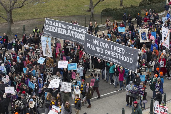 epa05755258 People walk on Constitution Avenue headed toward the Supreme Court while participating in the 44th March for Life, in Washington, DC, USA, 27 January 2017. Thousands of people gathered to  ...