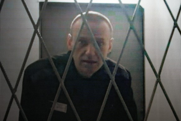 FILE - Russian opposition leader Alexei Navalny appears via a video link from the Arctic penal colony where he is serving a 19-year sentence, provided by the Russian Federal Penitentiary Service durin ...