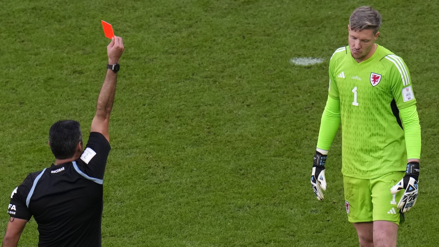 Referee Mario Alberto Escobar Toca shows a red card to Wales&#039; goalkeeper Wayne Hennessey during the World Cup group B soccer match between Wales and Iran, at the Ahmad Bin Ali Stadium in Al Rayya ...