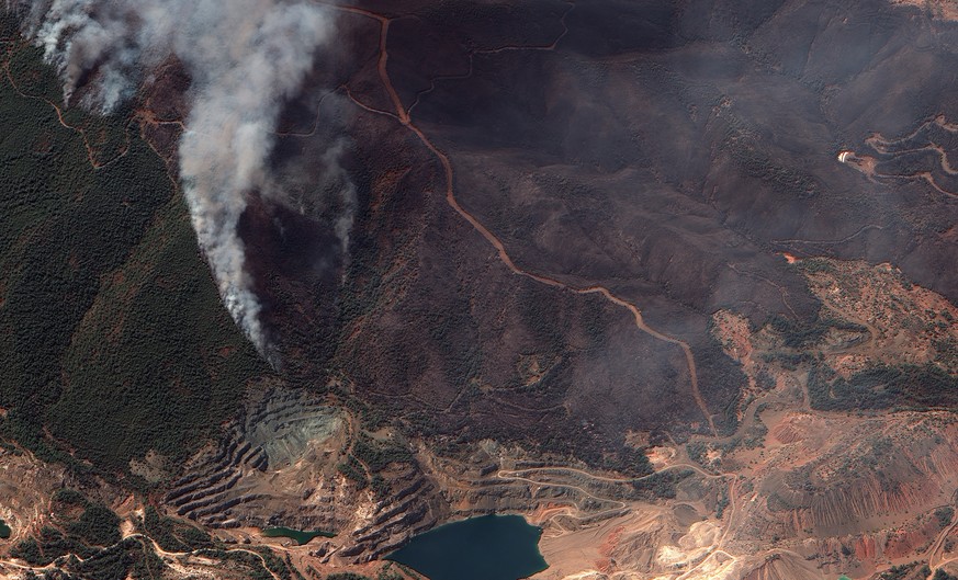 In this satellite image provided by Maxar Technologies wildfires burn north of Athens, Greece on the island of Evia, where some of the most destructive and active fires continue to burn, Sunday, Aug.  ...
