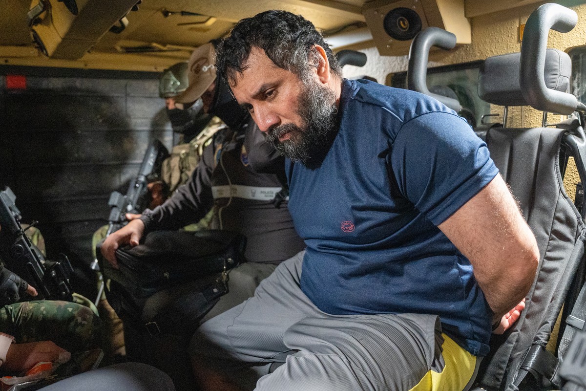 epaselect epa12198026 Drug trafficker Jose Adolfo Macias Villamar 'Fito' (R) is guarded as he is moved in Guayaquil, Ecuador, 25 June 2025. 'Fito' arrived at the Guayaquil Air Base ...