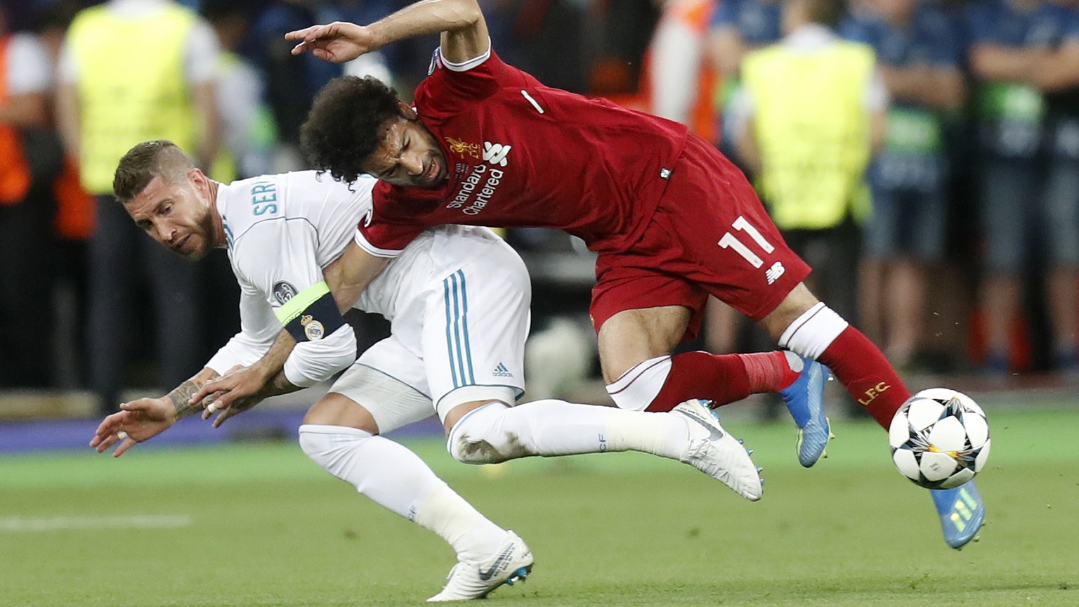 FILE - In this Saturday, May 26, 2018 file photo Real Madrid&#039;s Sergio Ramos, left, fouls Liverpool&#039;s Mohamed Salah during the Champions League Final soccer match between Real Madrid and Live ...