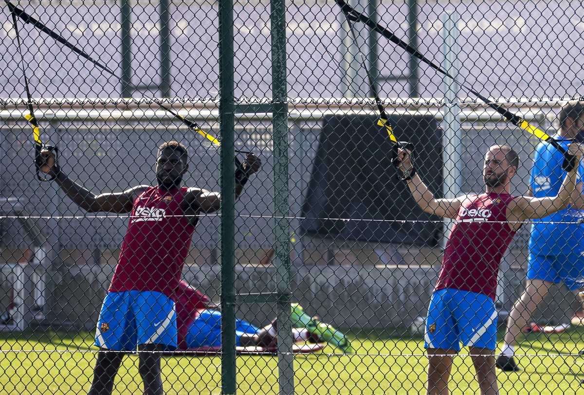 epa09359347 FC Barcelona players Samuel Umtiti (L) and Miralem Pjanic (R) attend a pre-season training session held at club's Sport City in Sant Joan Despi, Barcelona, Spain, 23 July 2021. EPA/Qu ...