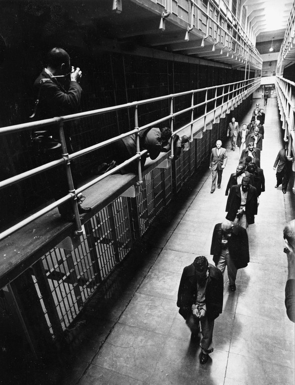 FILE In this March 21, 1963 file photo, a line of handcuffed prisoners, walk through the cell block as they are transferred to other prisons from Alcatraz Island in San Francisco. At dusk the island p ...
