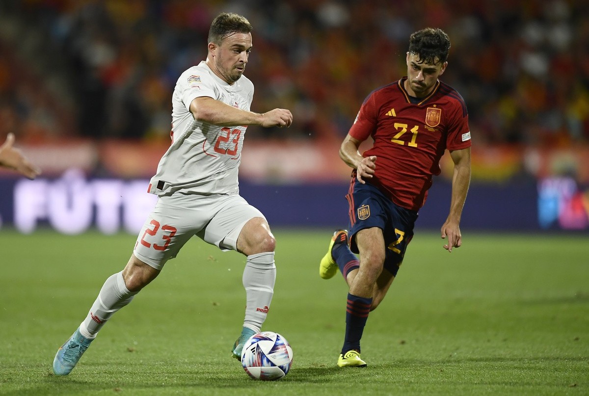 Switzerland's Xherdan Shaqiri, left, challenges for the ball with Spain's Pedri during the UEFA Nations League soccer match between Spain and Switzerland, at the Benito Villamarin Stadium, i ...
