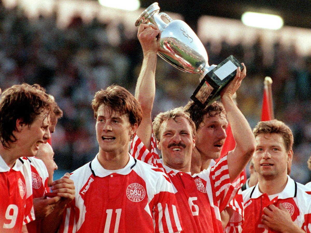 Die daenische Fussballnationalmannschaft bejubelt am 26.6.1992 in Goeteborg ihren ueberraschenden Sieg im Endspiel der Europameisterschaft. Abwehrspieler Kim Christofte (M) haelt triumphierend den ero ...