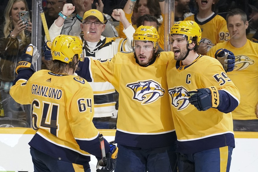 Nashville Predators&#039; Matt Duchene (95) celebrates with Mikael Granlund (64) and Roman Josi (59) after Duchene scored a goal against the Chicago Blackhawks in the second period of an NHL hockey ga ...