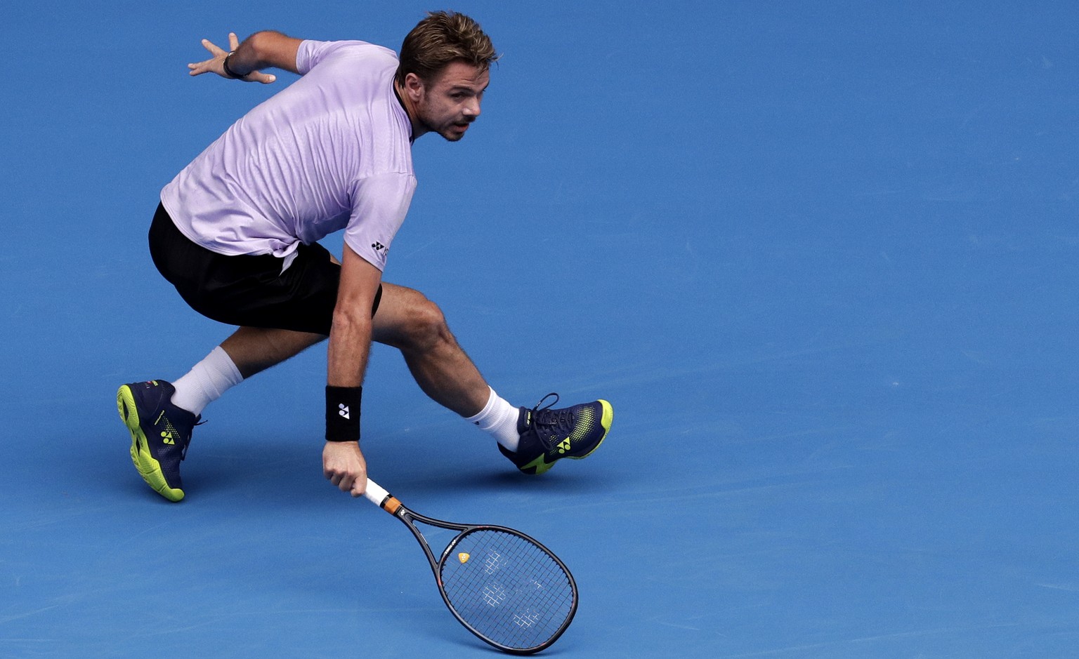 Switzerland&#039;s Stan Wawrinka plays a backhand return to Canada&#039;s Milos Raonic during their second round match at the Australian Open tennis championships in Melbourne, Australia, Thursday, Ja ...