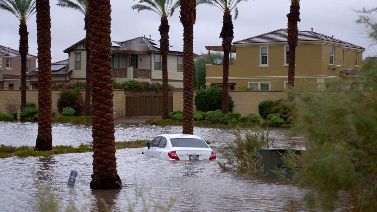 epa10811212 A car is submerged in flooded water as Tropical Storm Hilary arrives in Cathedral City, California, USA, 20 August 2023. Southern California is under a tropical storm warning for the first ...