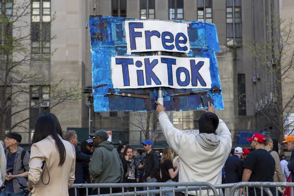 FILE - A man carries a Free TikTok sign in front of the courthouse where the hush-money trial of Donald Trump got underway April 15, 2024, in New York. The House has passed legislation Saturday, April ...