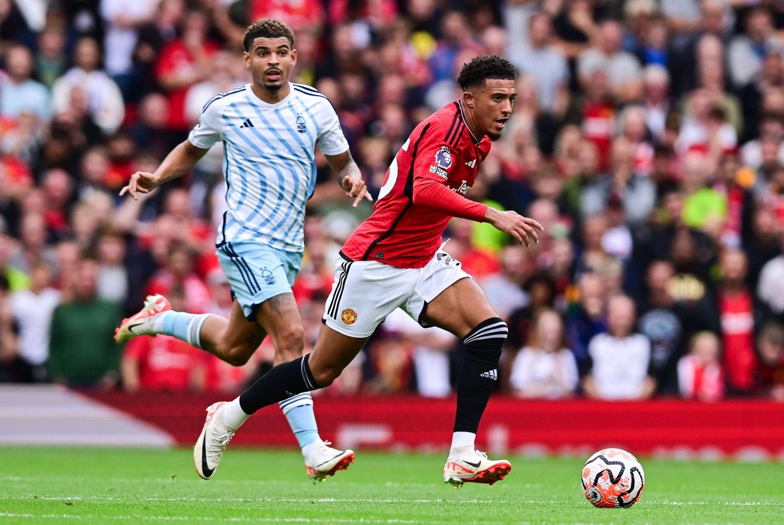 Mandatory Credit: Photo by Greig Cowie/Shutterstock 14067993dm Jadon Sancho of Manchester United, ManU and Morgan Gibbs-White of Nottingham Forest Manchester United v Nottingham Forest, Premier League ...