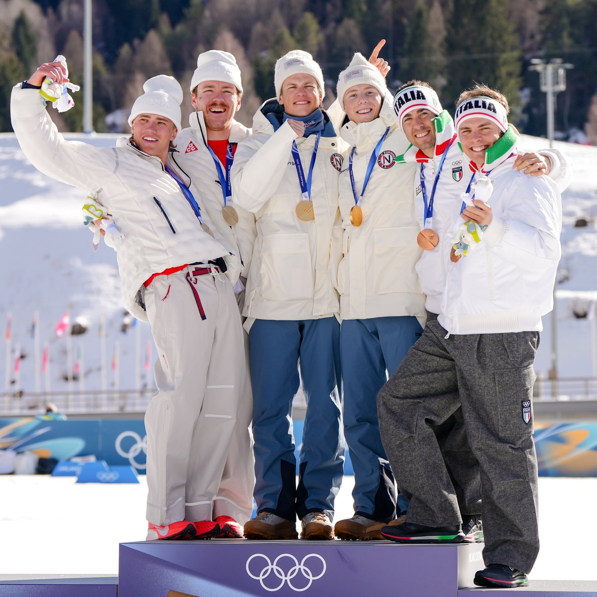 Silver medalists Ben Ogden and Gus Schumacher, of the United States, gold medalist Johannes Hoesflot Klaebo and Einar Hedegart, of Norway, and bronze medalist Elia Barp and Federico Pellegrino, of Ita ...
