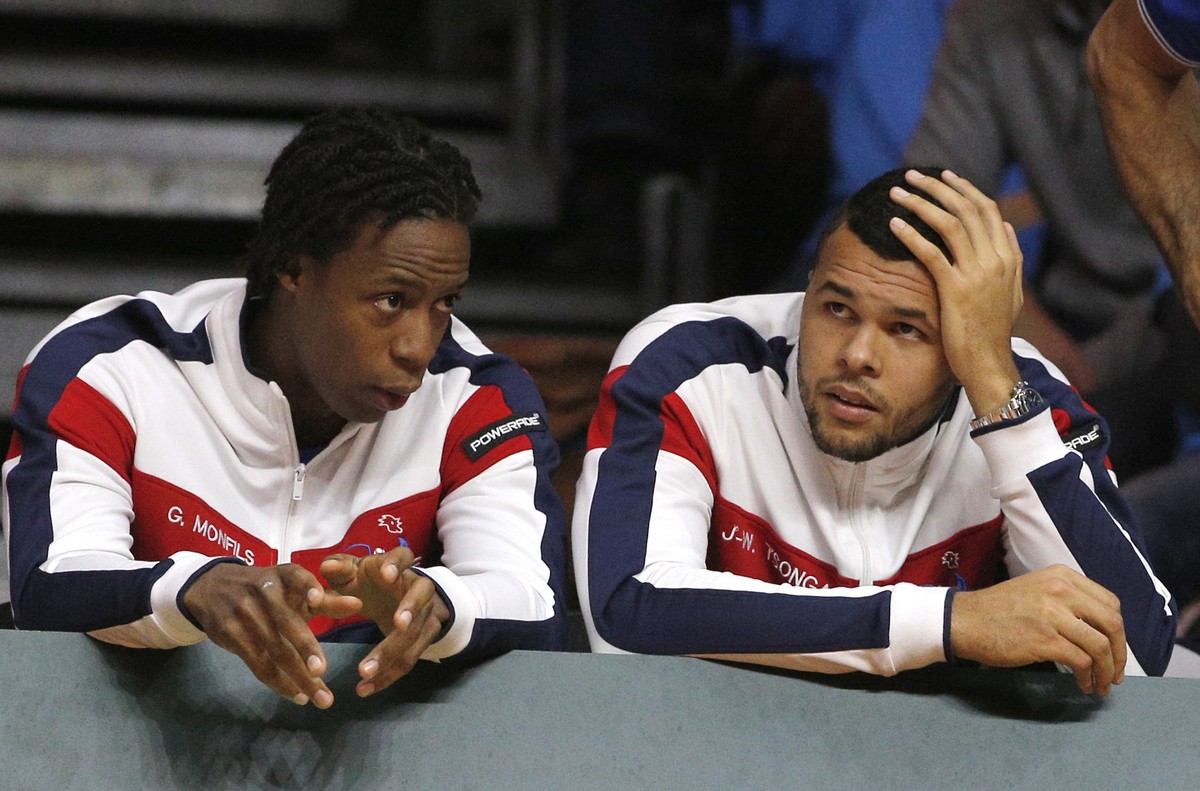 France's Gael Monfils, left, and Jo-Wilfried Tsonga watch compatriot Richard Gasquet playing Switzerland's Roger Federer during the Davis Cup final match in Lille, northern France, Sunday, N ...