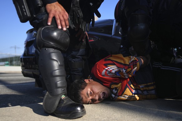 KEYPIX - A protester is arrested by California Highway Patrol near the federal building in downtown Los Angeles on Tuesday, June 10, 2025. (AP Photo/Eric Thayer)