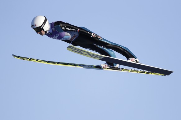 Simon Ammann of Switzerland soars through the air during his first competition jump at the second stage of the 65th four hills ski jumping tournament in Garmisch-Partenkirchen, Germany, Sunday, Jan. 1 ...