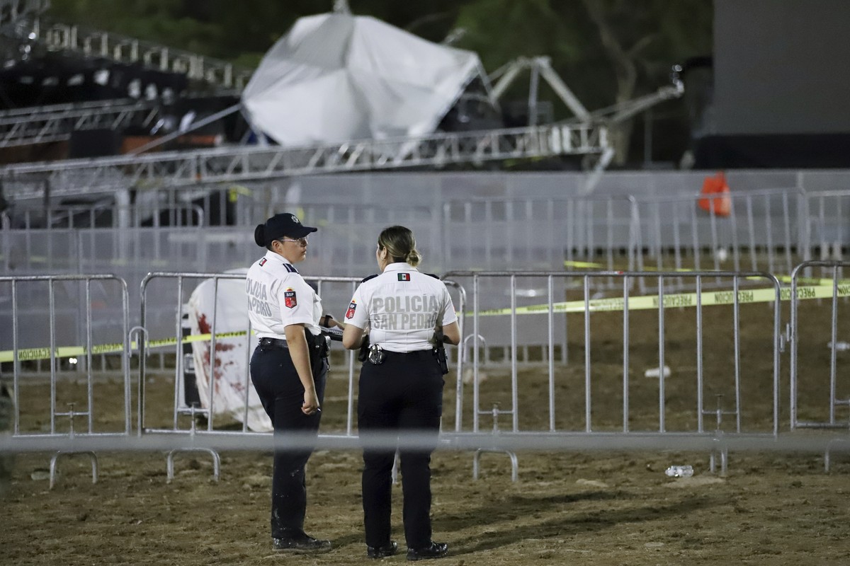 Security forces stand around a stage that collapsed due to a gust of wind during an event attended by presidential candidate Jorge