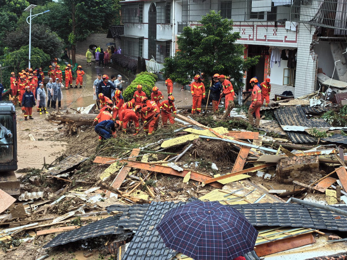 epa11502293 A handout photo made available by the Fire and Rescue Department of Hunan shows rescuers working at a landslide-hit area in Yuelin village of Shouyue Town in Hengyang City, central China,  ...