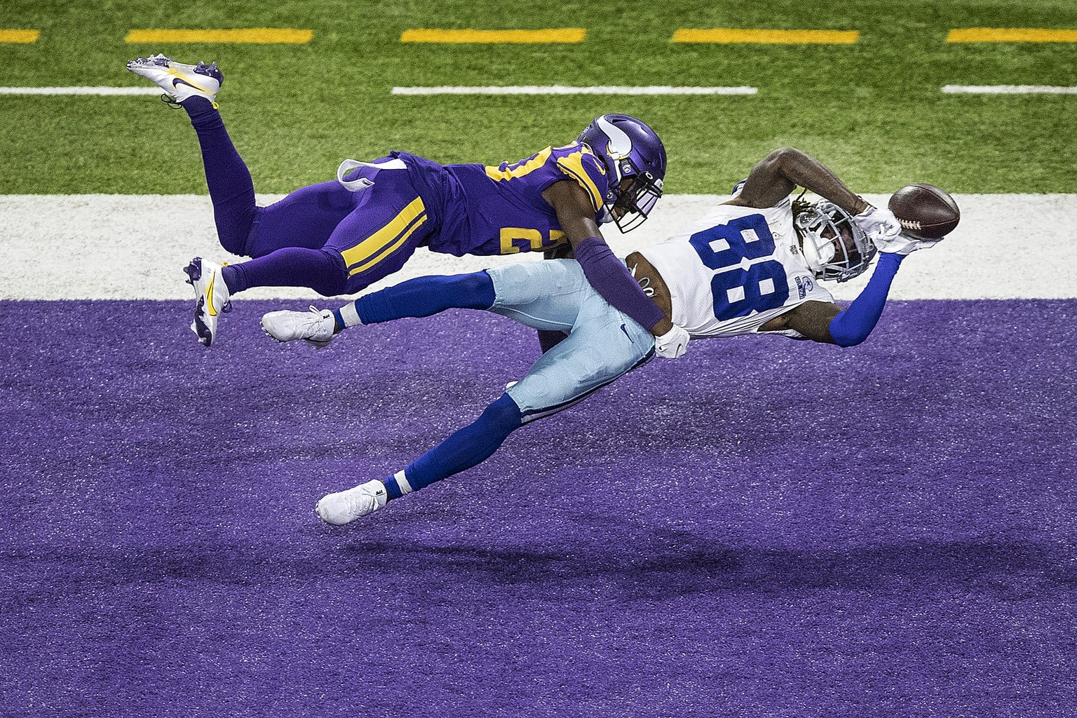 Dallas Cowboys wide receiver CeeDee Lamb (88) catches a second-quarter touchdown pass over Minnesota Vikings cornerback Jeff Gladney (20) during an NFL football game, Sunday, Nov. 22, 2020, in Minneap ...