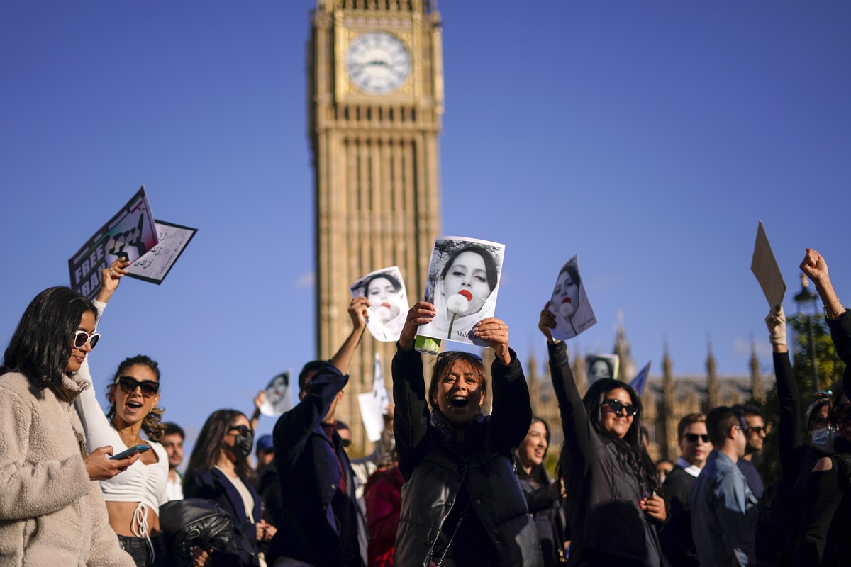 People take part in a protest against Iran's government in Parliament Square, in London, Saturday, Oct. 8, 2022. The protests erupted Sept. 17, after the burial of 22-year-old Mahsa Amini, a Kurd ...