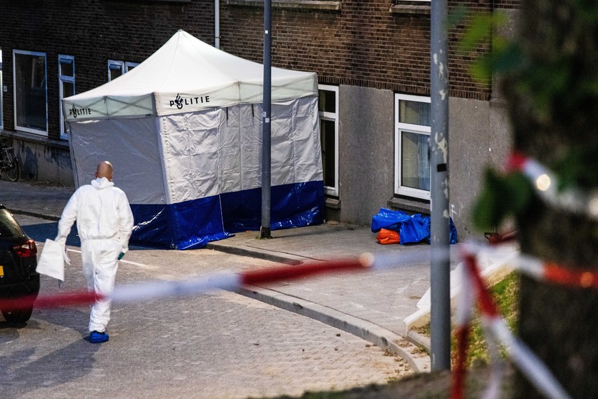 epa10888478 The police and fire brigade investigate the building on Heiman Dullaertplein where a 32-year-old man shot a 39-year-old woman and her 14-year-old daughter in Rotterdam, Netherlands, 28 Sep ...