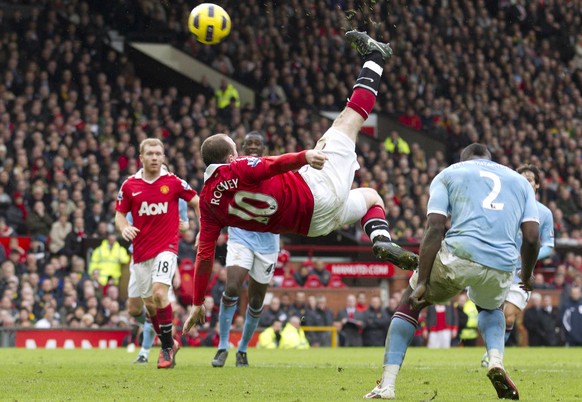 FILE - In this Feb. 12, 2011, file photo, Manchester United&#039;s Wayne Rooney, center, scores the game-winning goal with an overhead kick against Manchester City during their English Premier League  ...