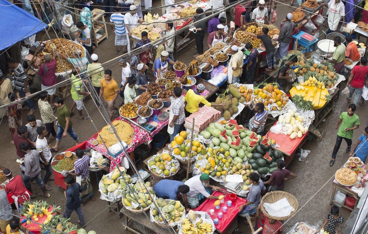 epa06752221 People buy food for breaking the fast during the Muslim's holy fasting month of Ramadan at traditional food market at Chalk bazar in Dhaka, Bangladesh, 20 May 2018. Muslims around the ...