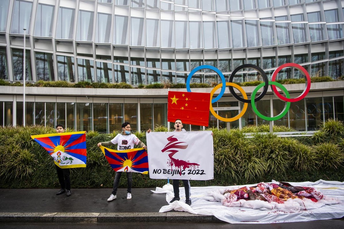 Protesters hold Tibetan flags during a protest against Beijing 2022 Winter Olympics by activists of the Tibetan Youth Association in Europe front of the International Olympic Committee, IOC, headquart ...