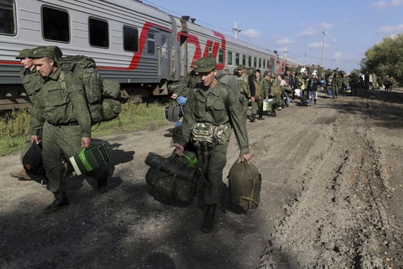 Russian recruits walk to take a train at a railway station in Prudboi, Volgograd region of Russia, Thursday, Sept. 29, 2022. Russian President Vladimir Putin has ordered a partial mobilization of rese ...
