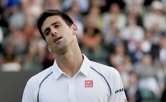 epa04834518 Novak Djokovic of Serbia in action against Kevin Anderson of South Africa during their fourth round match for the Wimbledon Championships at the All England Lawn Tennis Club, in London, Br ...