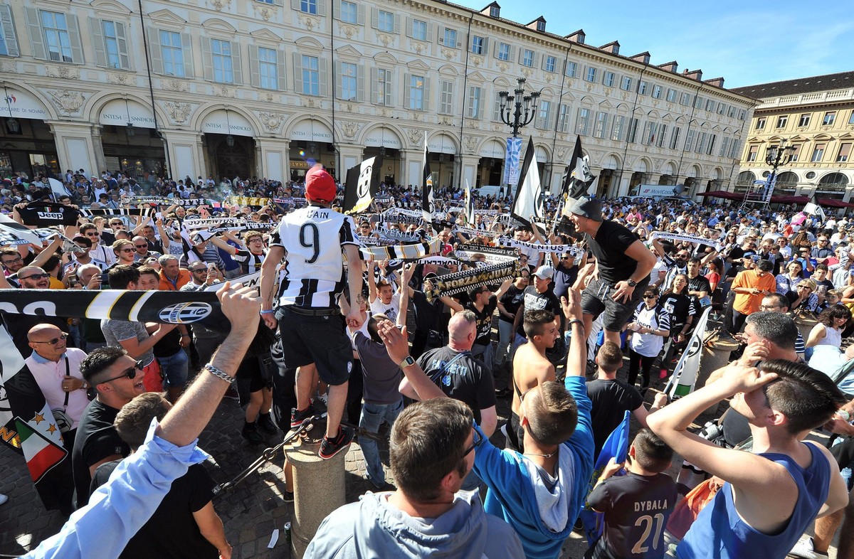 Juventus fans celebrate as their team won an unprecedented sixth consecutive Italian title, at the end of the Serie A soccer match between Juventus and Crotone, at San Carlo's square in Turin, It ...
