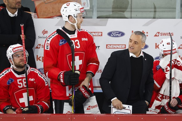 Switzerland's head coach Jan Cadieux reacts next to his players Simon Le Coultre, Dario Meyer and Jonas Taibel, from left, during a friendly ice hockey match between Switzerland and Hungary, Thur ...
