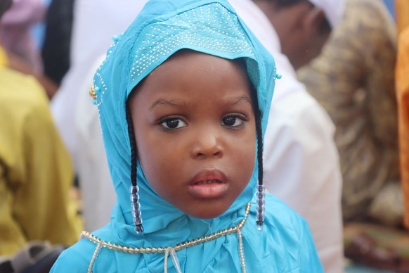 YAOUNDE, CAMEROON - JUNE 28: Cameroonians who went out to perform Eid al-Adha prayers in the early hours of the morning create colorful images on the streets with their Eid clothes in Yaounde, Cameroo ...