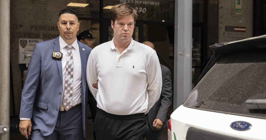 William Duplessie is escorted out of the New York Police 13th Precinct after turning himself in on charges of kidnapping and false imprisonment, Tuesday, May 27, 2025, in New York. (AP Photo/Yuki Iwam ...