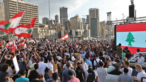 epa08597700 Anti-government protestors gather near the devastated harbor area to commemorate the victims of the explosion that took place just one week earlier, in Beirut, Lebanon, 11 August 2020. The ...