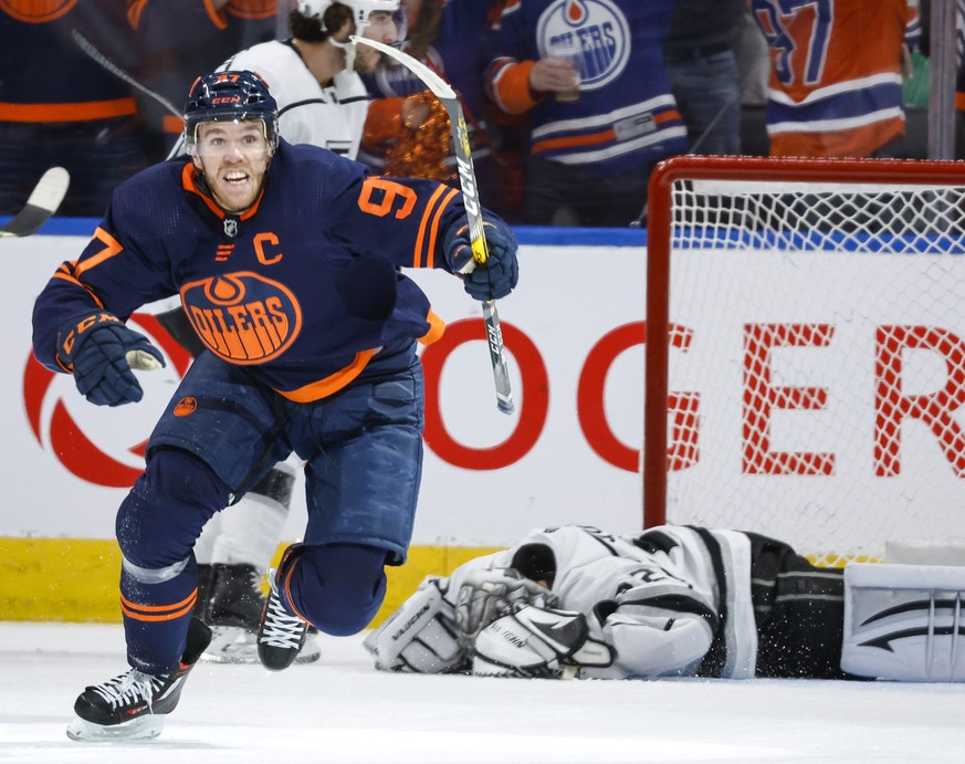 Los Angeles Kings goalie Jonathan Quick, right, lies on the ice as Edmonton Oilers center Connor McDavid celebrates his goal during the third period in Game 7 of a first-round series in the NHL hockey ...