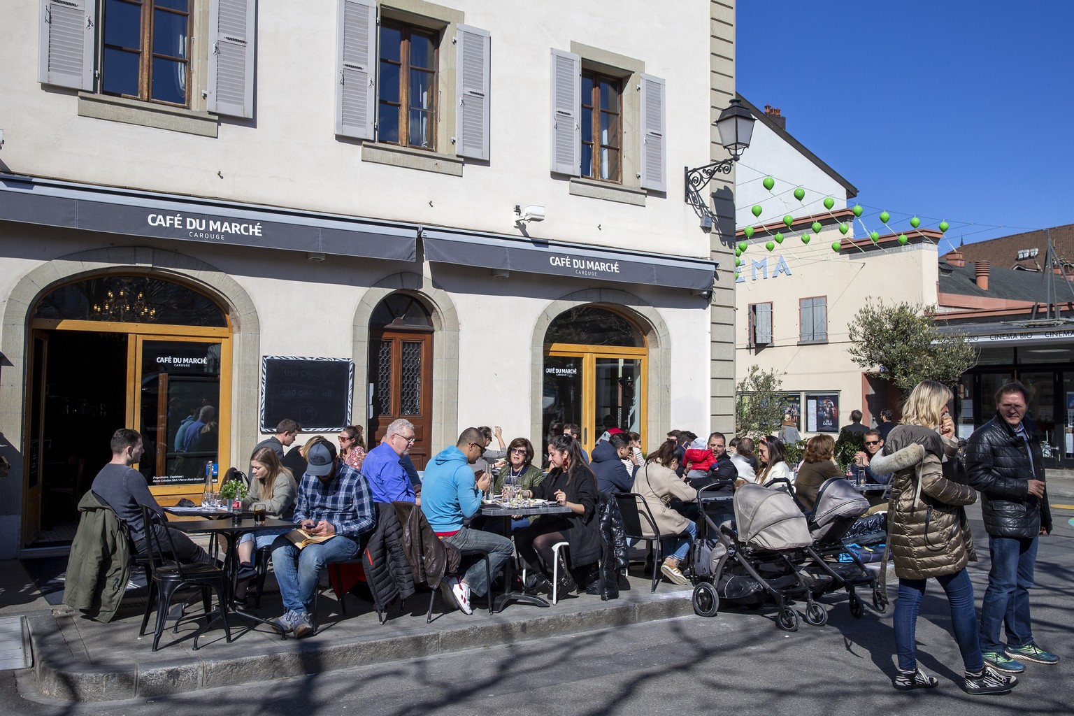 epa08294691 Customers gather on terace of the Cafe du Marche with social distance as part of measures to contain the spread of coronavirus COVID-19, in Carouge near Geneva, Switzerland, 14 March 2020. ...