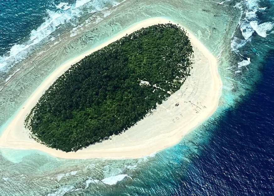 epa08582827 A handout photo made available by the US Coast Guard shows an aerial view of Pikelot Island, in the Federated States of Micronesia, 03 August 2020 (issued 04 August 2020), where three men  ...