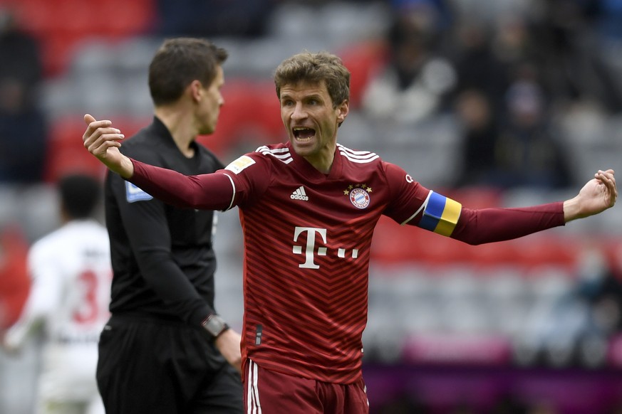 Bayern&#039;s team captain Thomas Mueller wears an armband in the Ukrainian flag colors during the German Bundesliga soccer match between FC Bayern Munich and Bayer 04 Leverkusen at the Allianz Arena  ...
