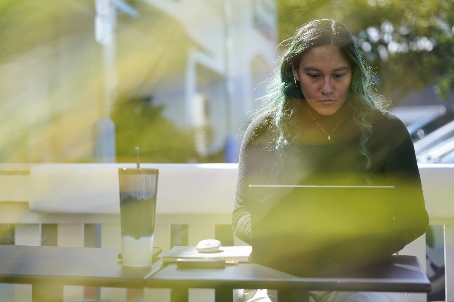 Daniella Malave works on her laptop at a coffee shop in Sea Girt, N.J., Thursday, Sept. 29, 2022. While working full time for Chipotle, Malave completed two years of community college with annual stip ...