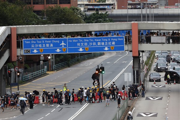 Protesters place barricades on a highway during a demonstration in Hong Kong, Saturday, Aug. 3, 2019. Hong Kong protesters ignored police warnings and streamed past the designated endpoint for a rally ...