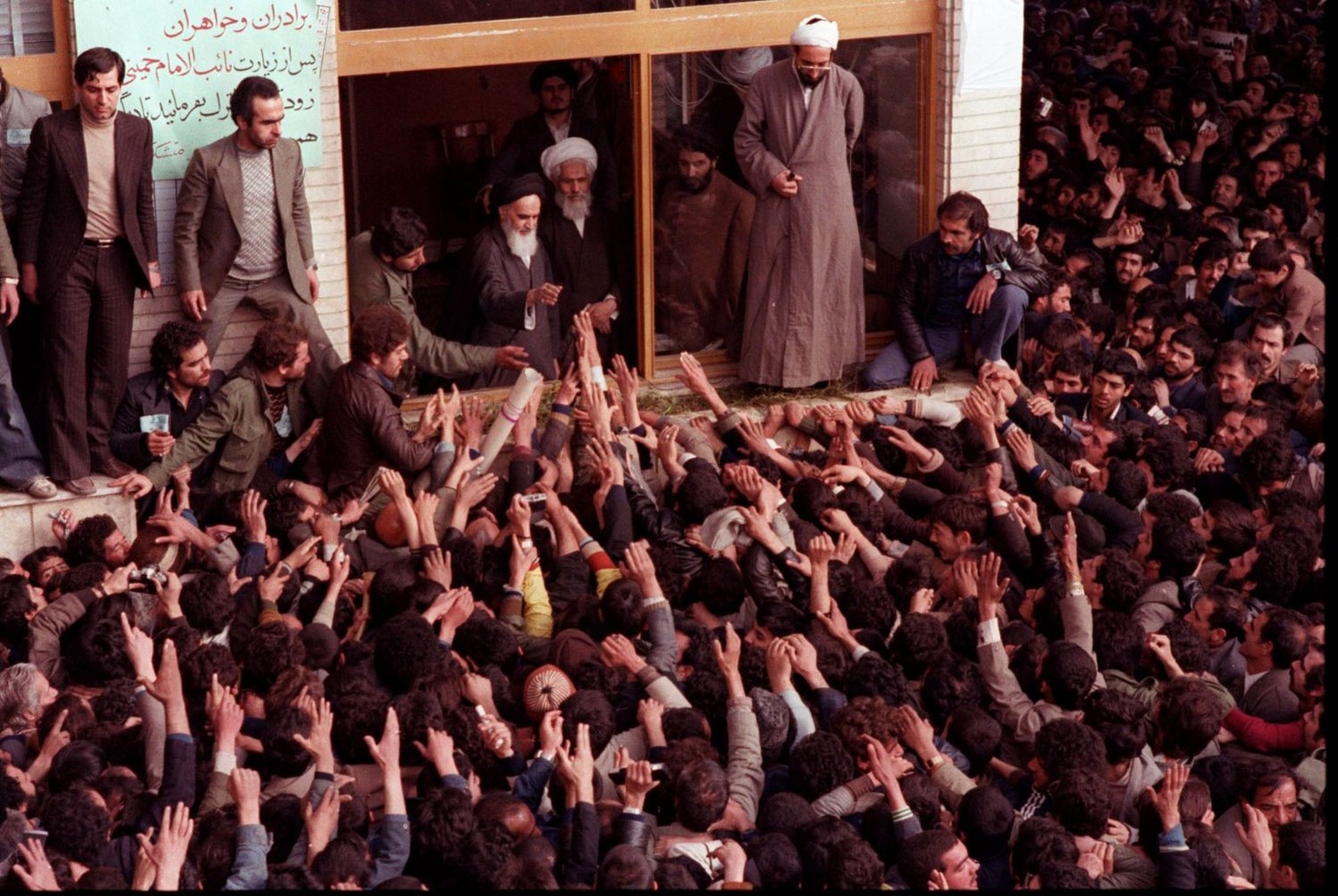The late Ayatollah Ruhollah Khomeini, center, is greeted by supporters after arriving at the airport in Tehran Iran in this February 1, 1979 photo. (KEYSTONE/AP Photo/Str)